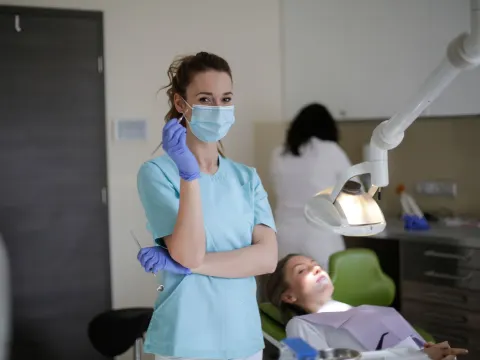 Dentist and assistant with a patient in a modern clinic
