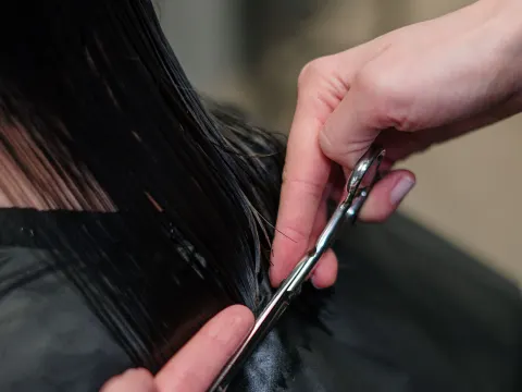 Hairdresser cutting a client’s hair in a salon