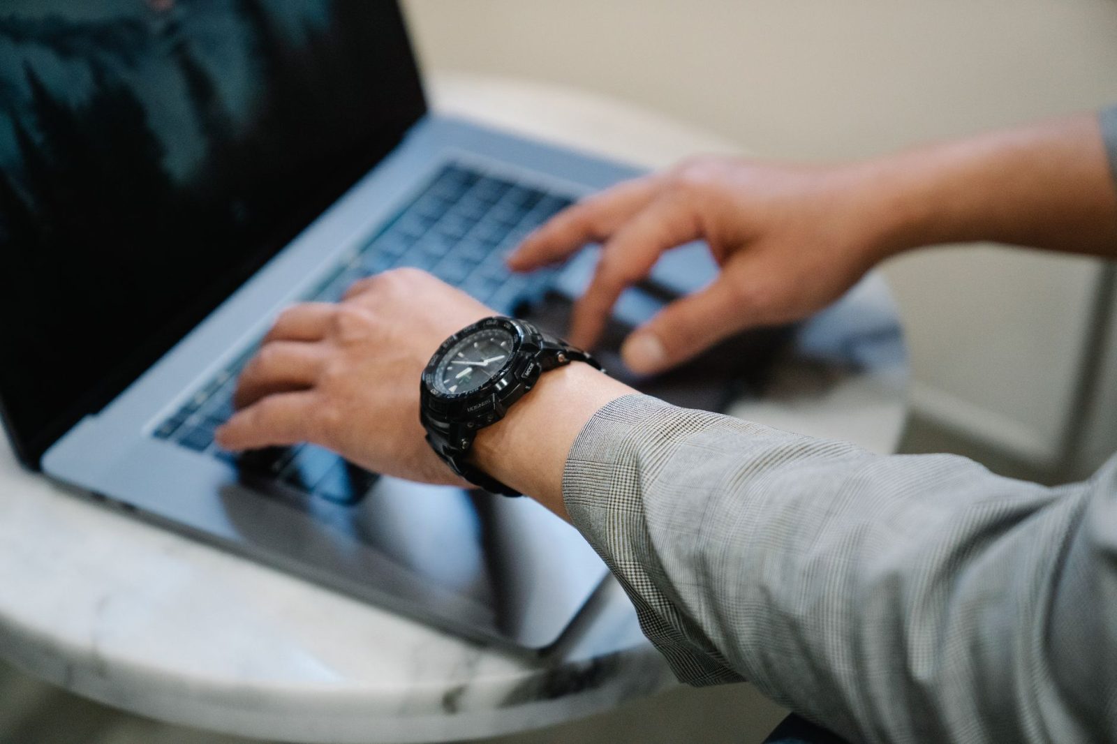 person typing on laptop computer
