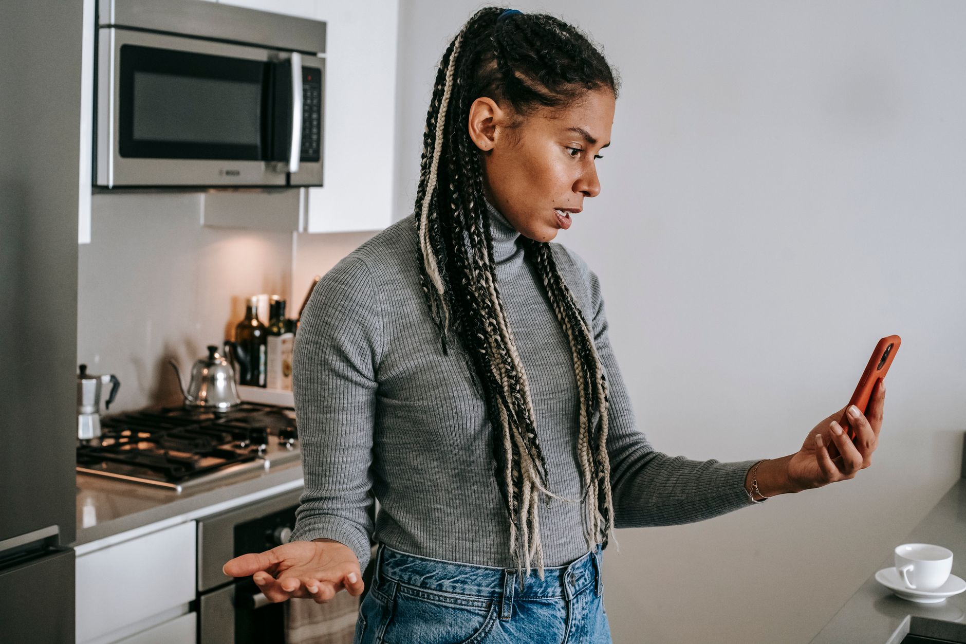 teenager looking at phone concerned worried