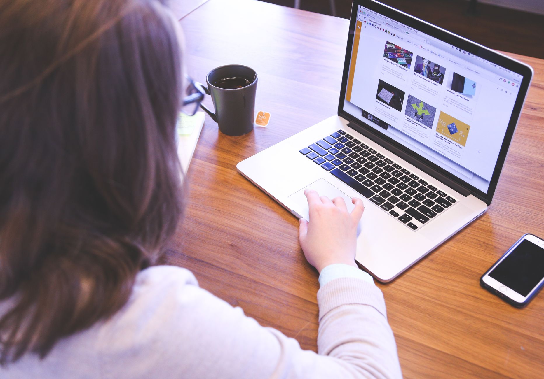 small business owner at computer working on website