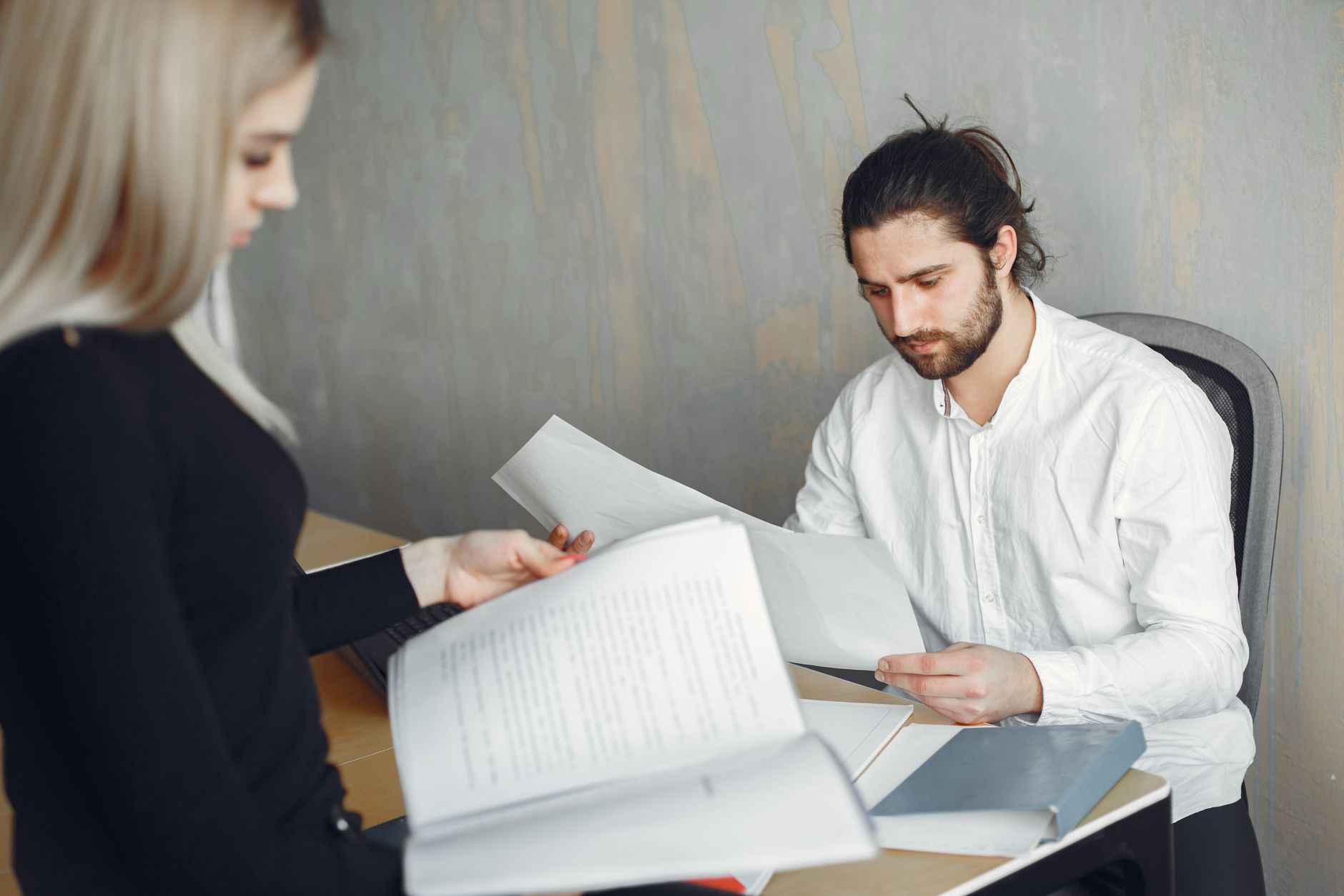 manager and employee discussing performance review document