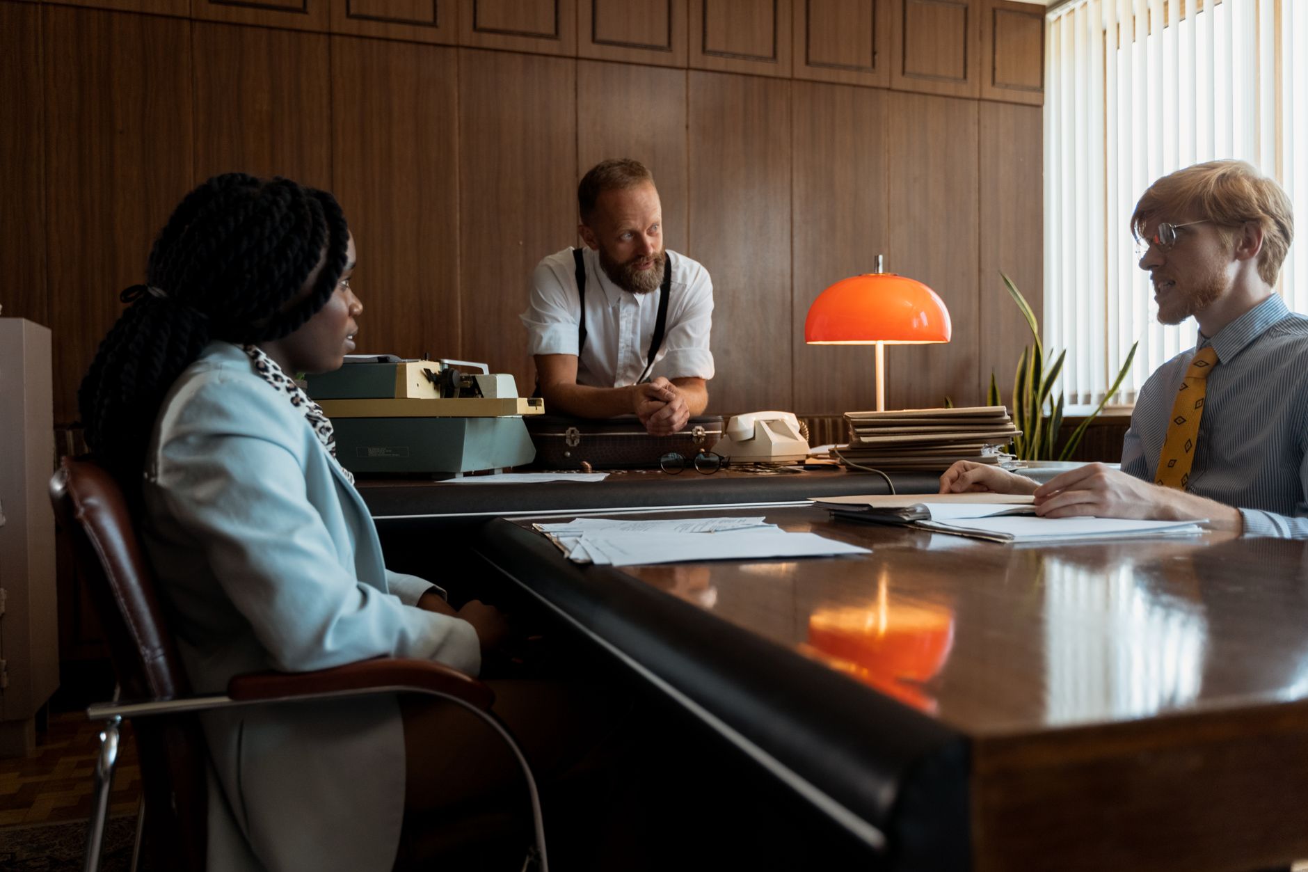 manager meeting with employee at desk discussing performance